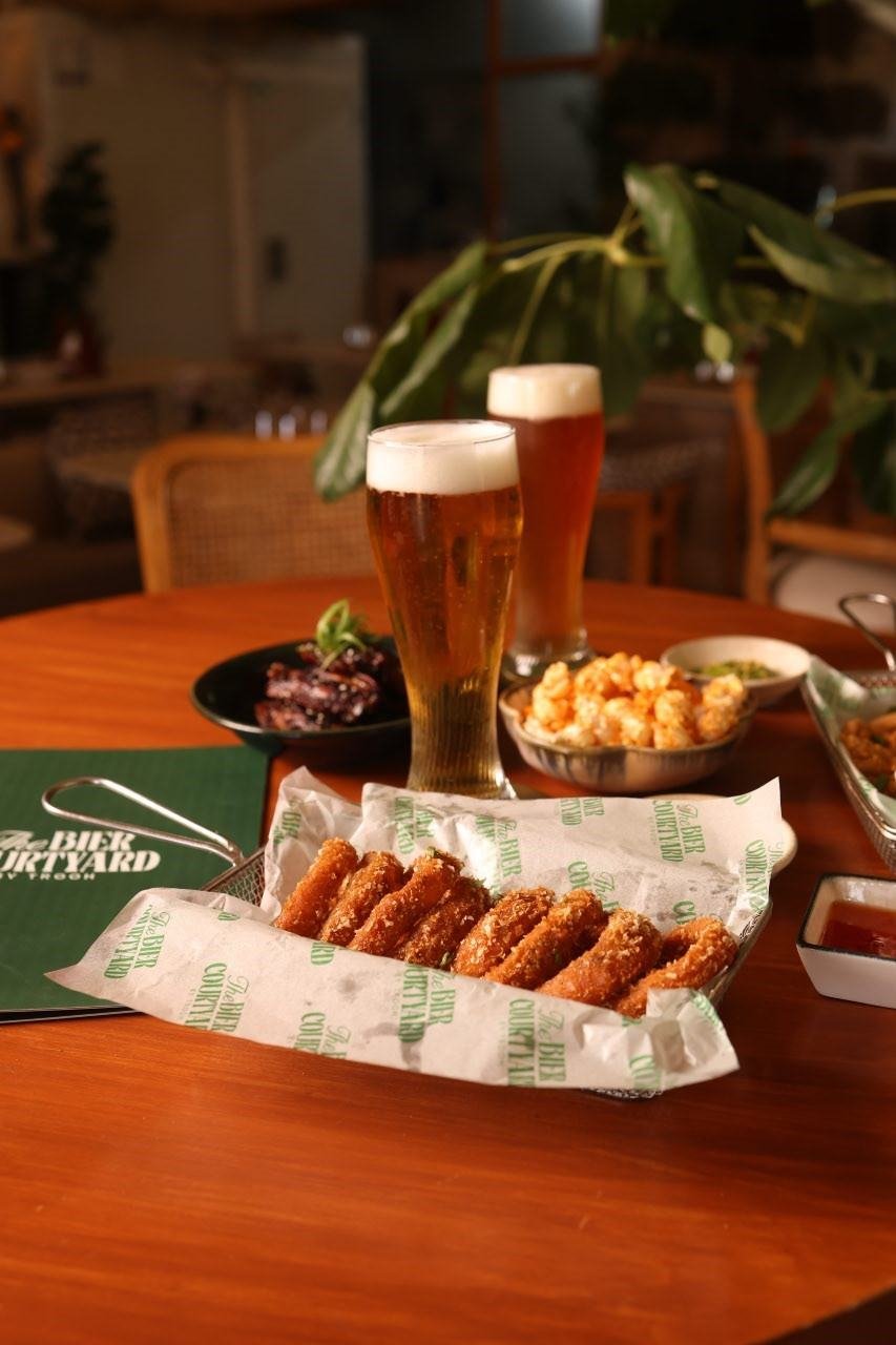 Craft beer with onion rings on the courtyard table at TBC